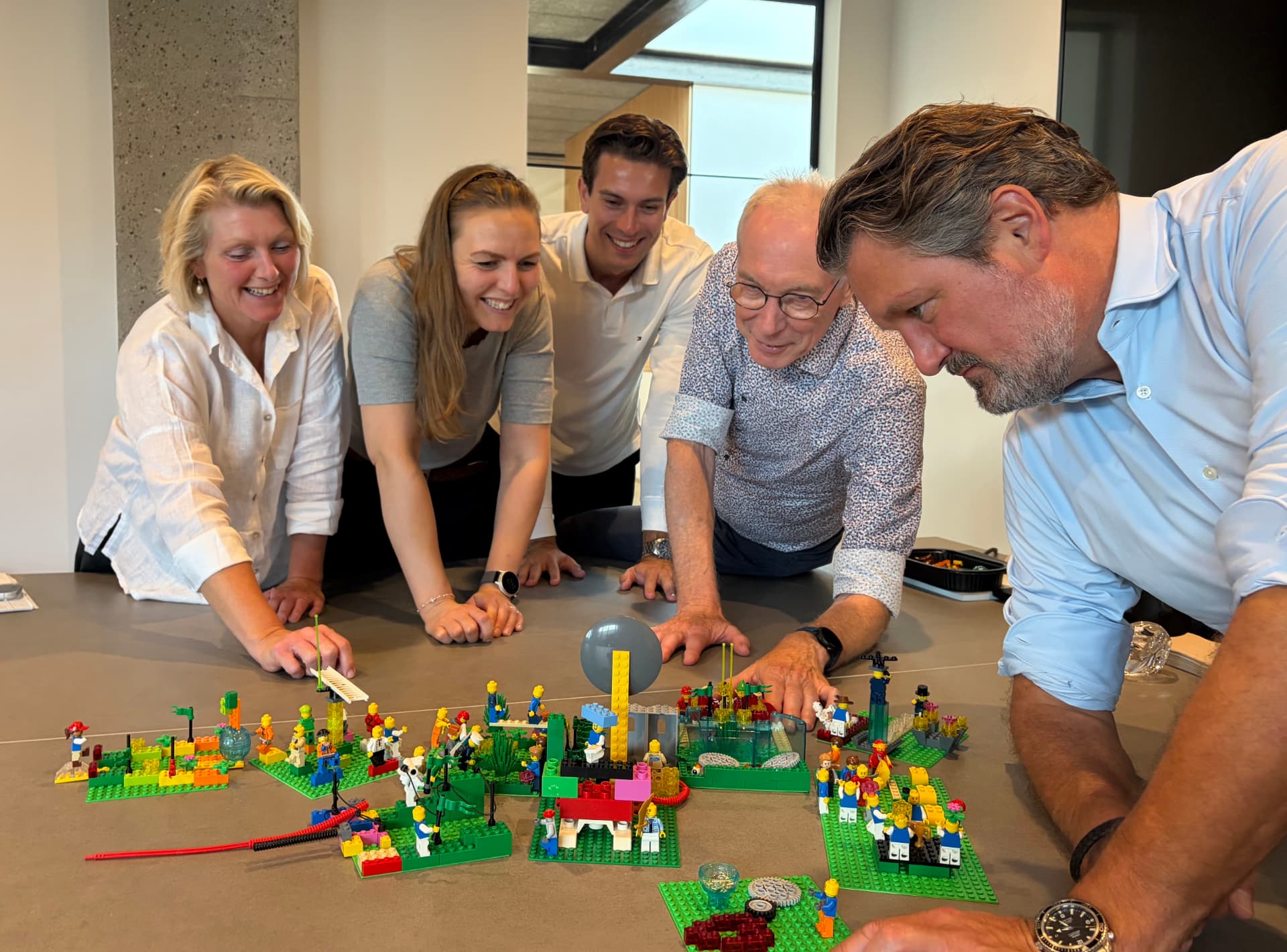 Johan Roos working with a team around a LEGO Serious Play model landscape.